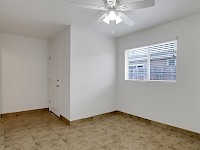 Downstairs bedroom with door to side patio