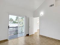 East bedroom off living room with access to east deck