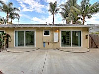 Sliding doors off bedrooms lead to back patio