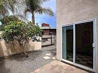 West side yard with lemon tree and access from Master Bedroom